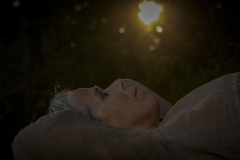 Last Light, Fine art photograph of a woman resting peacefully beneath the last light of the setting sun, symbolizing stillness and serenity.