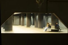 Street photography focused on everyday life at a trainstation, stillness, and subtle human interaction.