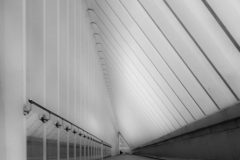 Street photography focused on everyday life waiting on a train, stillness, and subtle human interaction.